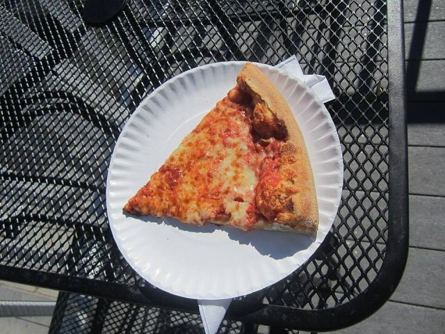 Representative photo: People of Boston, eating PIZZA, Newbury Street, $1 slice of pizza, Trust ME Bernie Madoff Pizza. Not this venue.