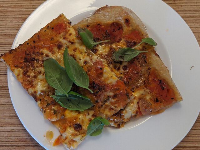 Representative photo: Margherita pizza on plate. Not this venue.