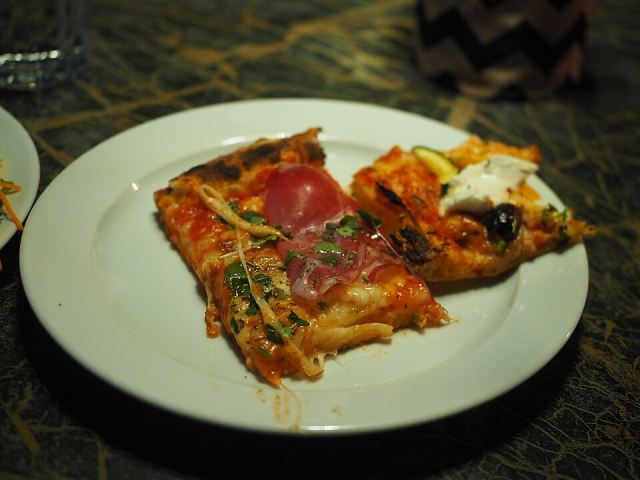 Representative photo: Pizza al taglio on a plate at restaurant Red Onion. Not this venue.